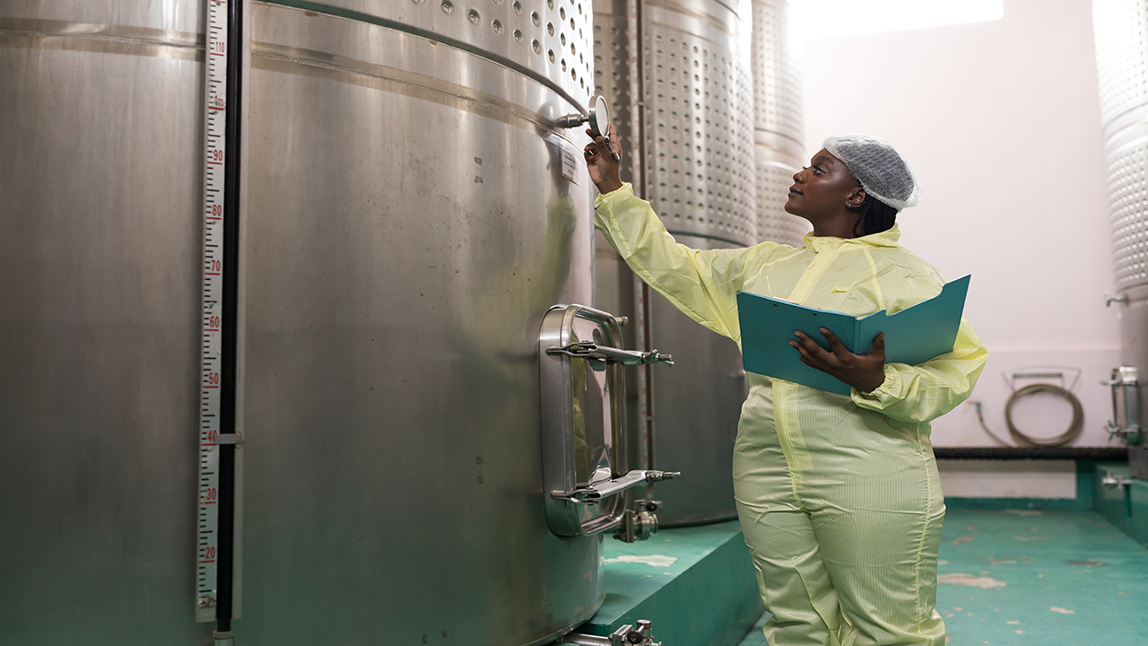 operator inspecting tank