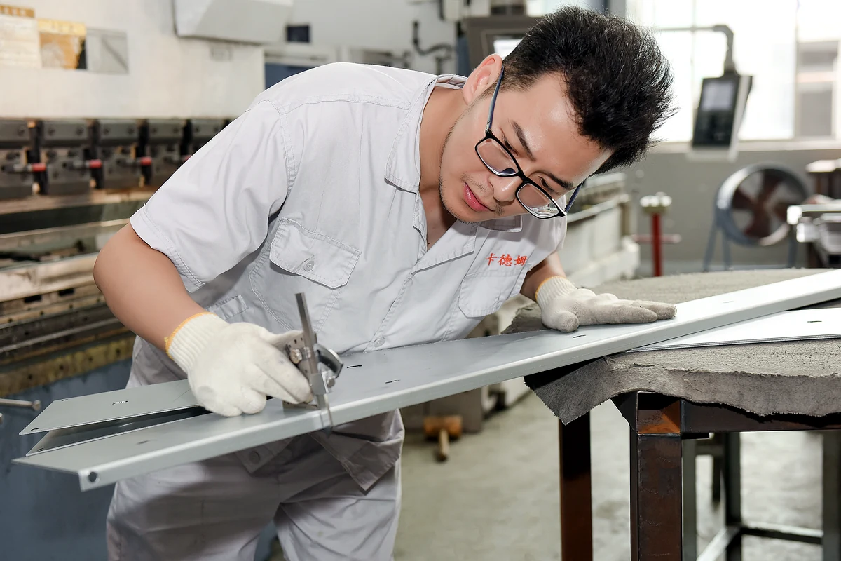Inspector checking a fabricated electrical enclosure panel