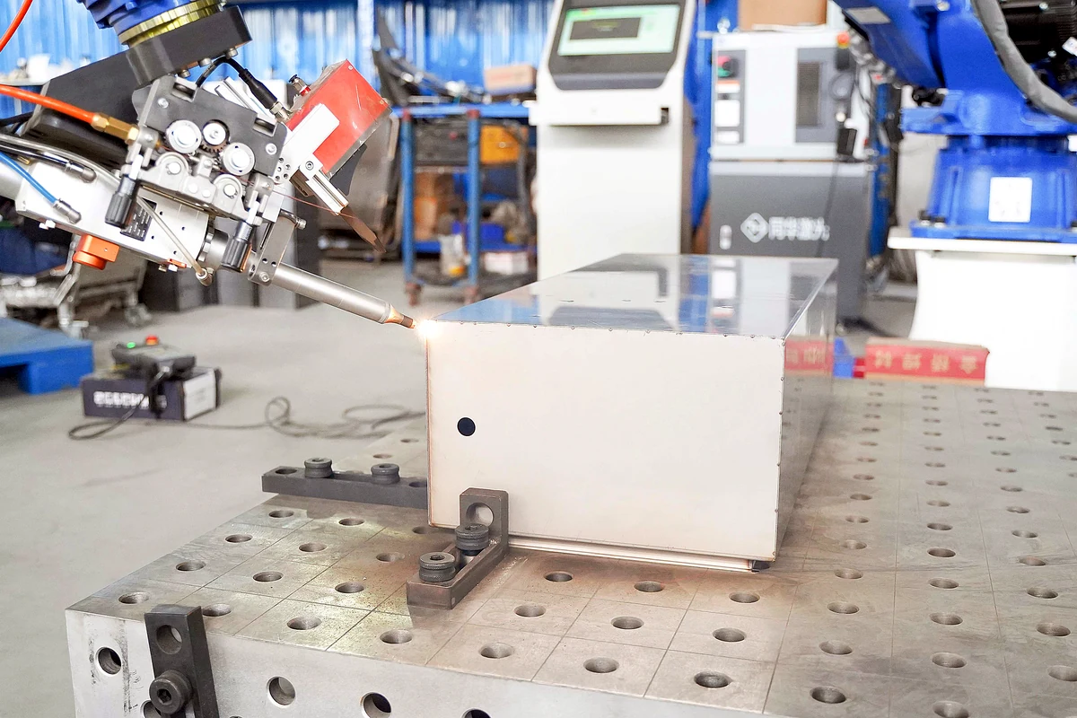 Automated laser welding head joining an electrical enclosure